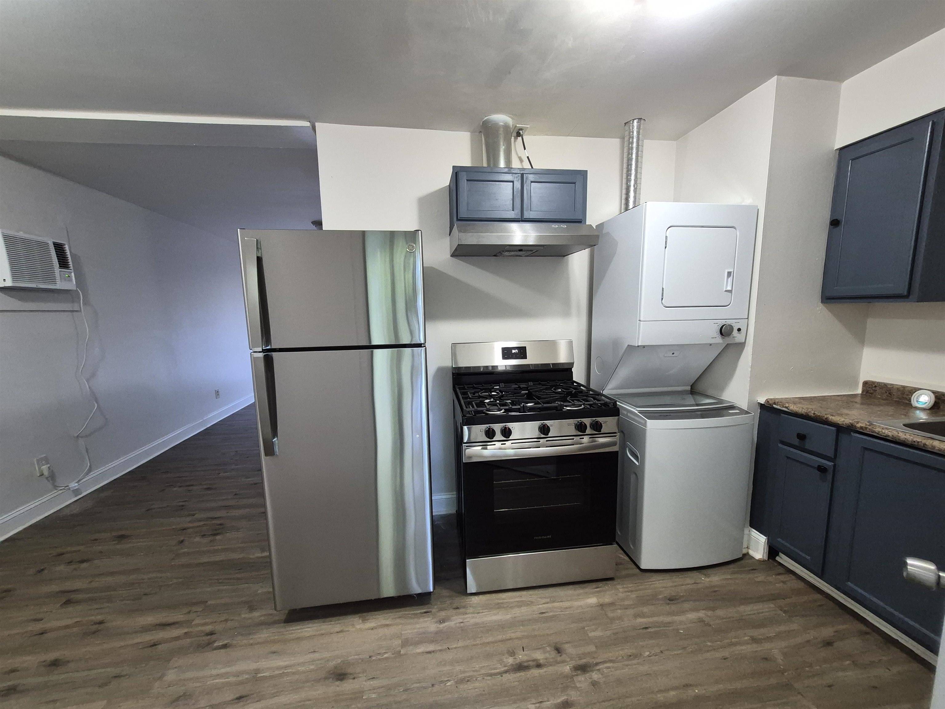 3449 Tutwiler Avenue, Unit 3449 Memphis, TN 38122 - Photo 3 of 10 a kitchen with a refrigerator stove and wooden floor