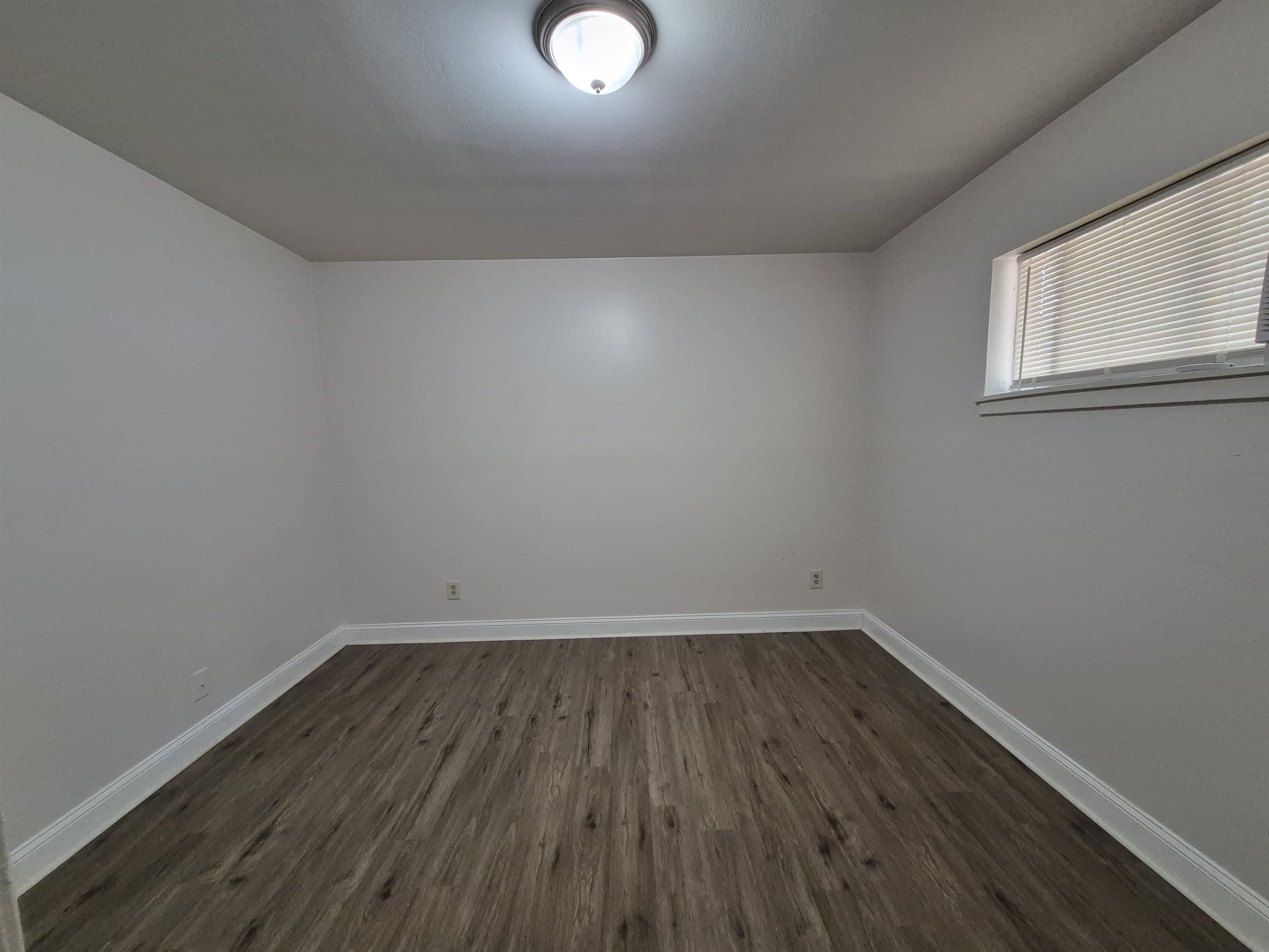 3449 Tutwiler Avenue, Unit 3449 Memphis, TN 38122 - Photo 7 of 10 a view of wooden floor and windows in a room