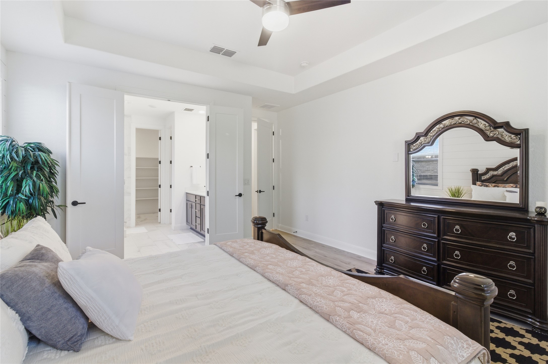 2032 Rushing Ranch Path Georgetown, TX 78628 - Photo 16 of 30 Elegant tray ceilings and luxury wood flooring define this peaceful main bedroom retreat.