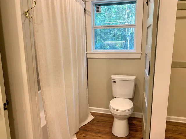 a bathroom with a toilet and a window