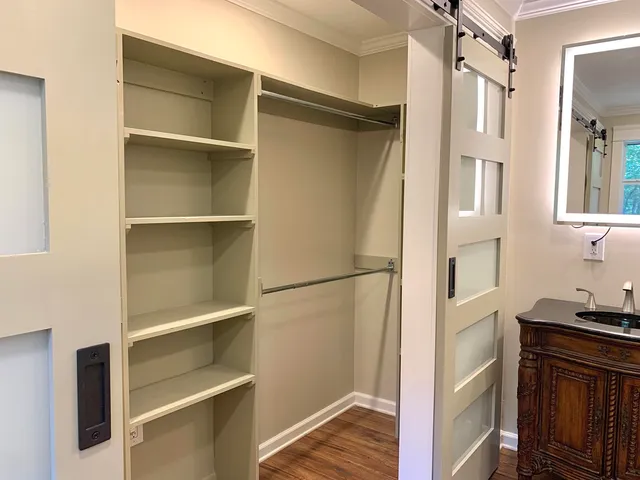 a view of walk in closet with empty racks
