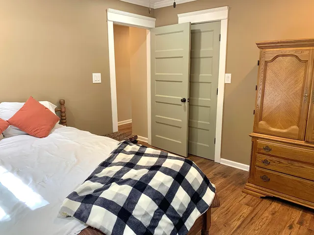 a bedroom with a bed and cabinets