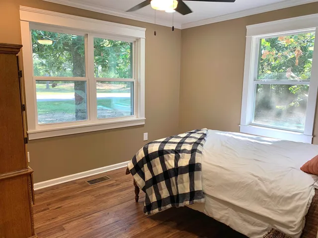 a bedroom with a bed and a window