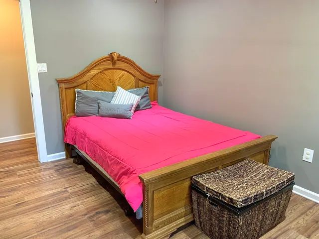 a bedroom with a bed and a dresser