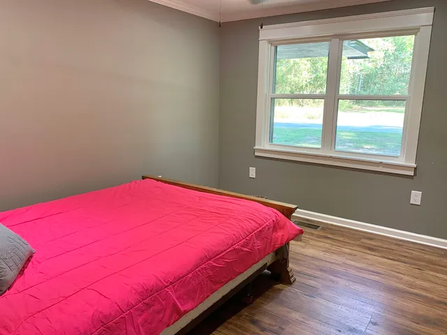 a bedroom with a bed and a window