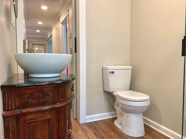a bathroom with a toilet and a mirror