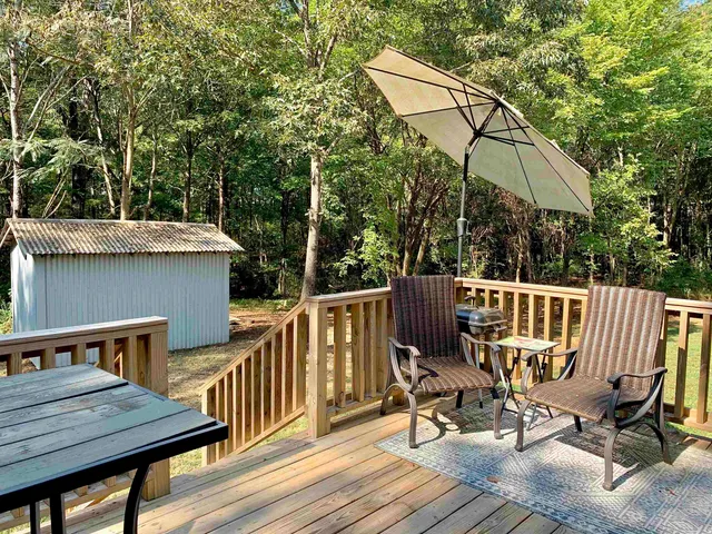 a backyard of a house with wooden fence and trees