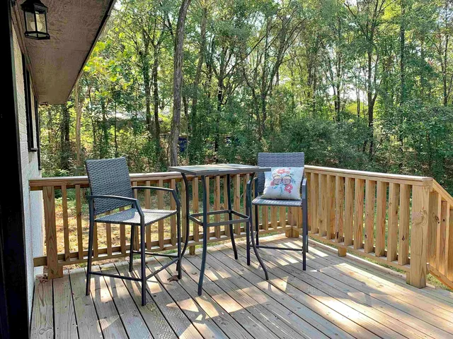 a house with green field in front of it