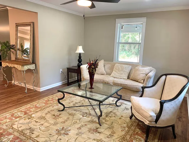 a living room with furniture and wooden floor