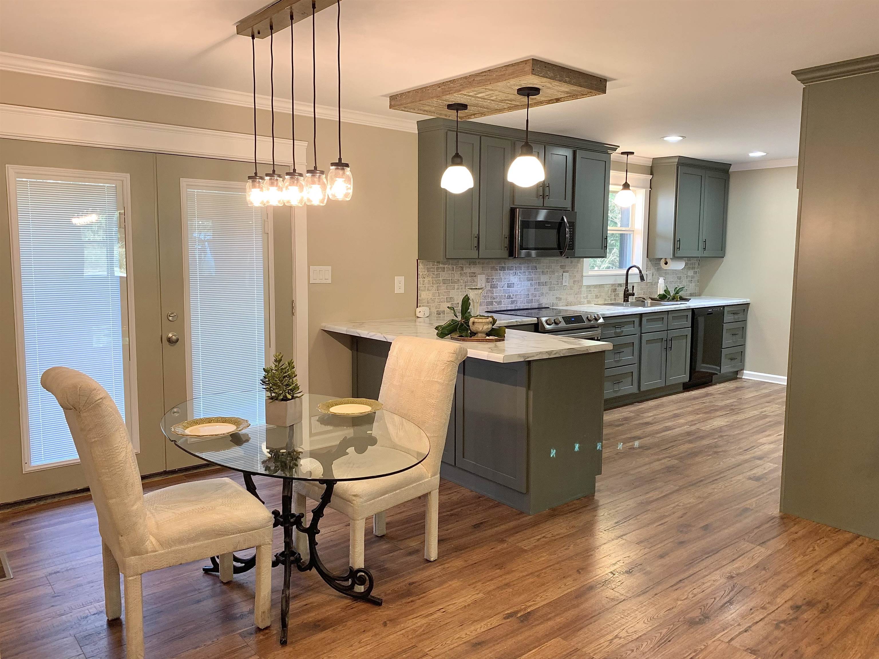 17 Cr 747 Road Walnut, MS 38683 - Photo 7 of 35 a kitchen with a table chairs and wooden floor