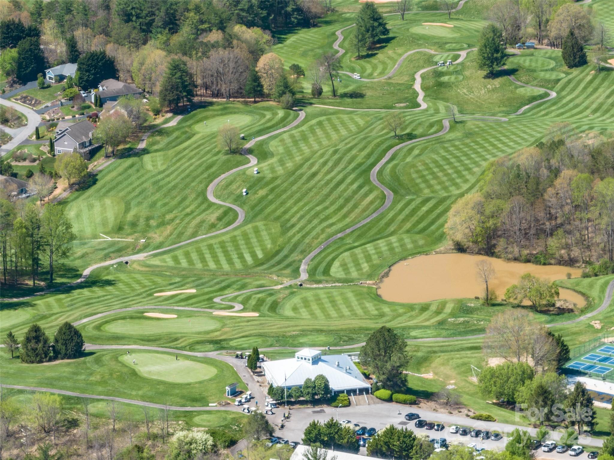 88 Courseview Drive, Unit 239 Weaverville, NC 28787 - Photo 7 of 16 a view of a table chairs and an umbrella