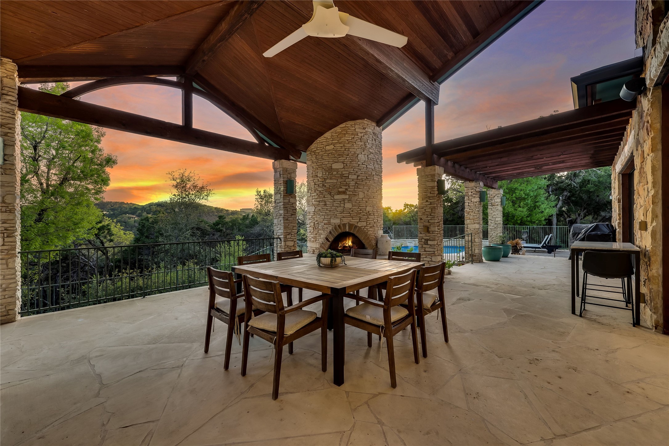 1016 Wild Basin Ledge Austin, TX 78746 - Photo 28 of 38 View of terrace with an outdoor stone fireplace, a pergola, and a pool