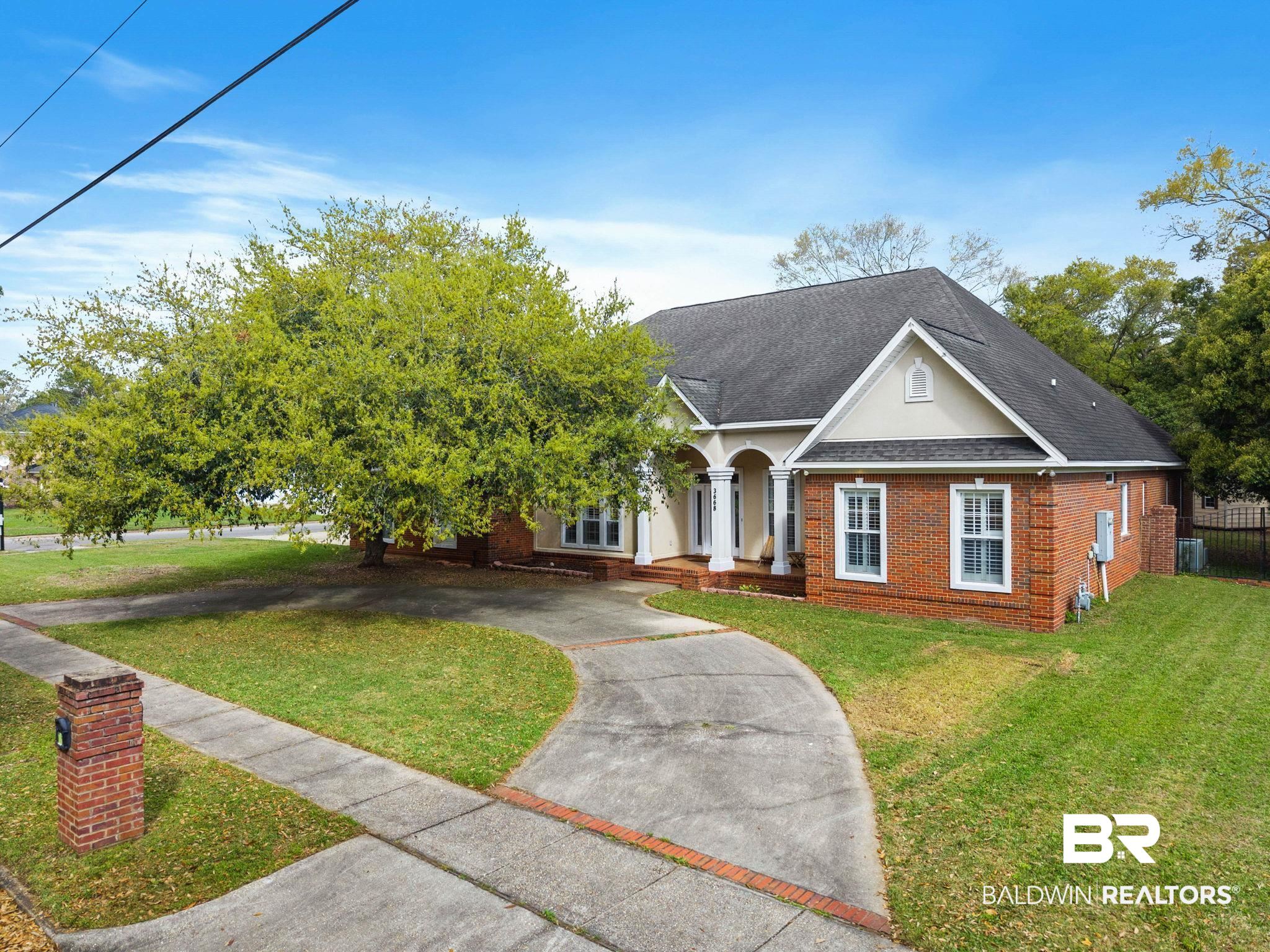 3668 Claridge Road North Mobile, AL 36608 - Photo 6 of 100 View of front of property with brick siding, a shingled roof, a front yard, and stucco siding