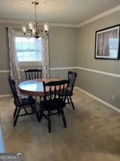 a view of a dining room with furniture and chandelier