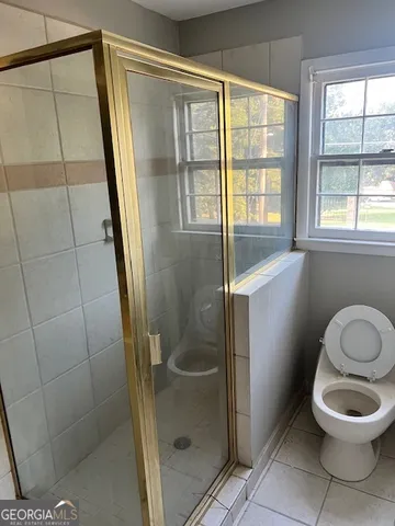 a bathroom with a toilet and a shower