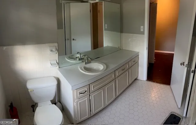 a bathroom with a toilet sink and mirror