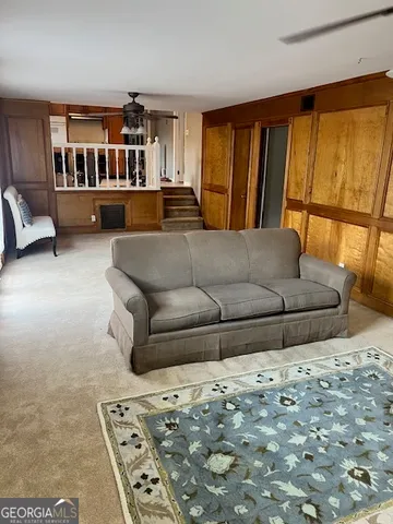 a living room with furniture and a rug
