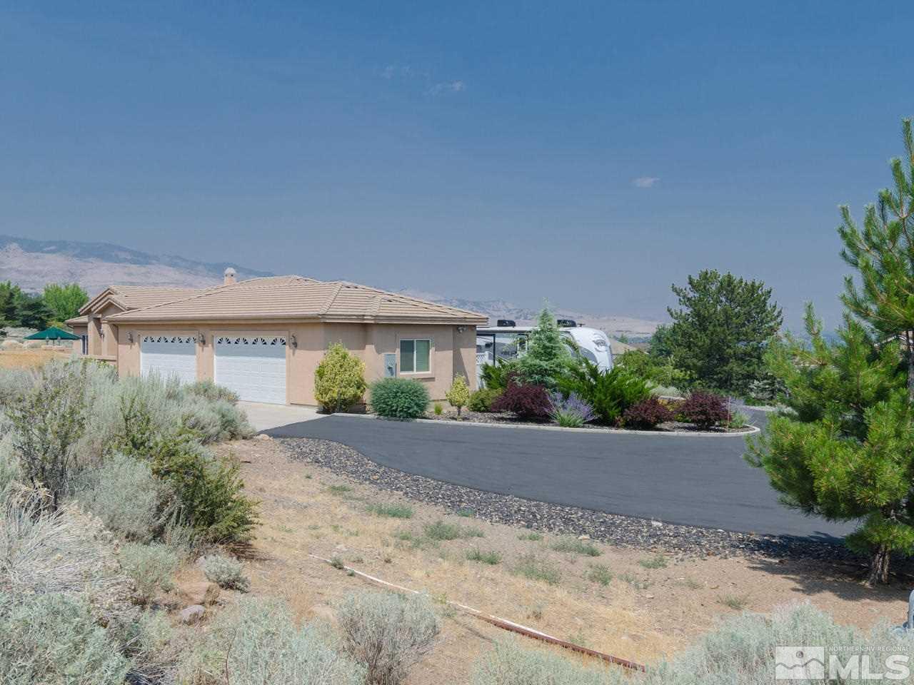 12615 Thomas Creek Road Reno, NV 89511 - Photo 3 of 25 a view of a house with a yard and plants