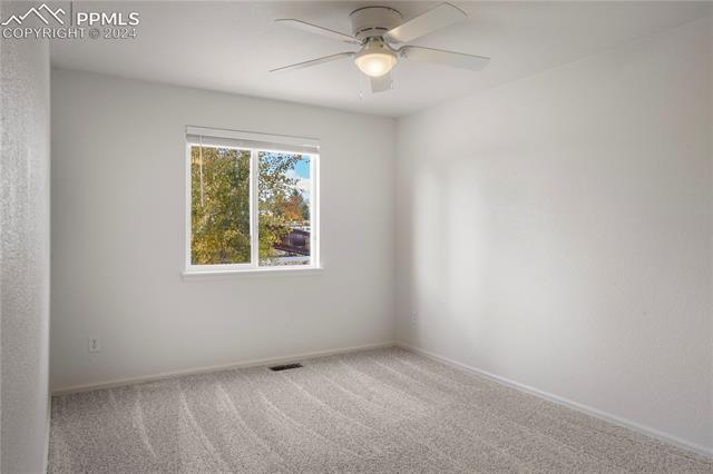 8271 Del Rio Road Peyton, CO 80831 - Photo 17 of 34 Main level bedroom 2 with newer carpet and paint