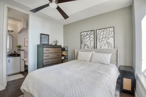 a bedroom with a bed and a dresser