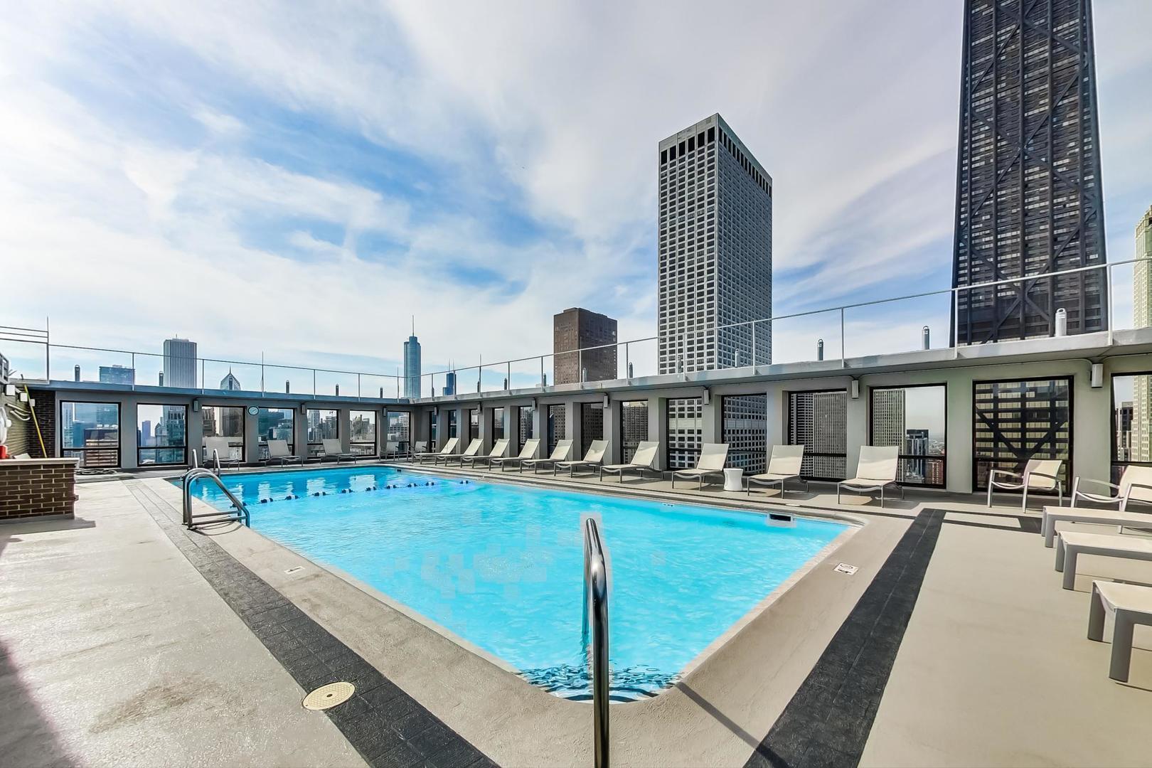 260 East Chestnut Street, Unit 1111 Chicago, IL 60611 - Photo 23 of 29 a swimming pool view with a outdoor seating space