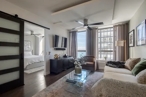 a living room with furniture and a large window