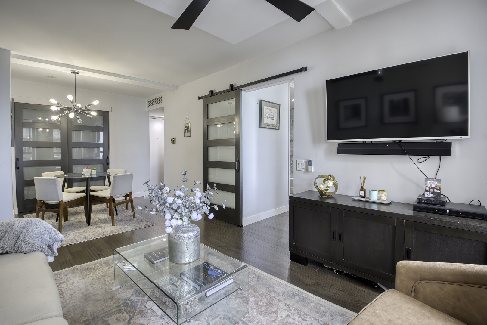 260 East Chestnut Street, Unit 1111 Chicago, IL 60611 - Photo 9 of 29 a living room with furniture a flat screen tv and kitchen view