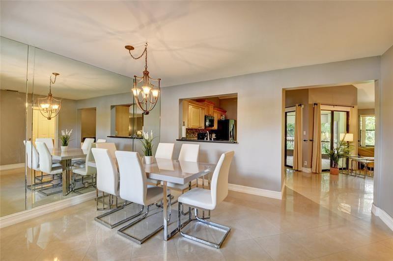 9316 Ketay Circle Boca Raton, FL 33428 - Photo 4 of 30 a view of a dining room with furniture window and wooden floor