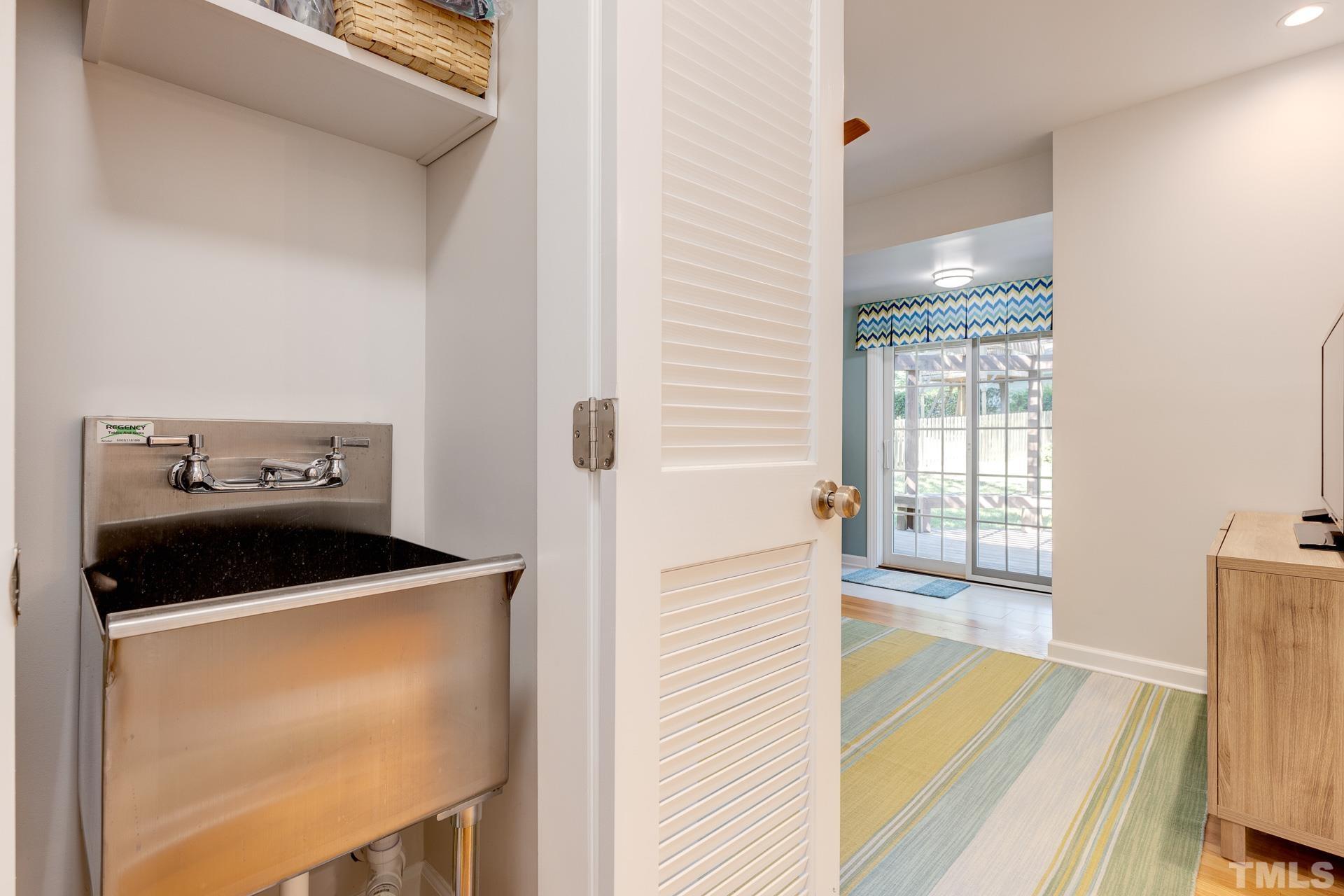 613 Ortega Road Raleigh, NC 27609 - Photo 15 of 37 a kitchen with a refrigerator and a sink