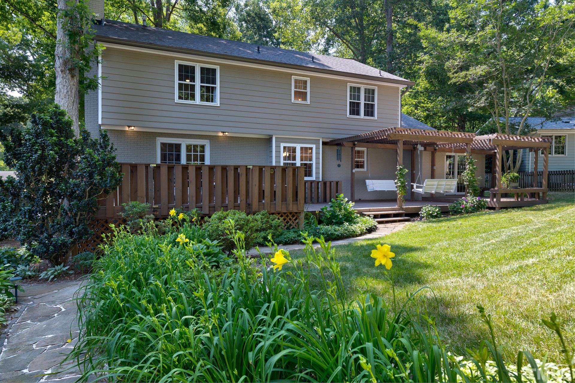 613 Ortega Road Raleigh, NC 27609 - Photo 29 of 37 a front view of a house with garden and porch