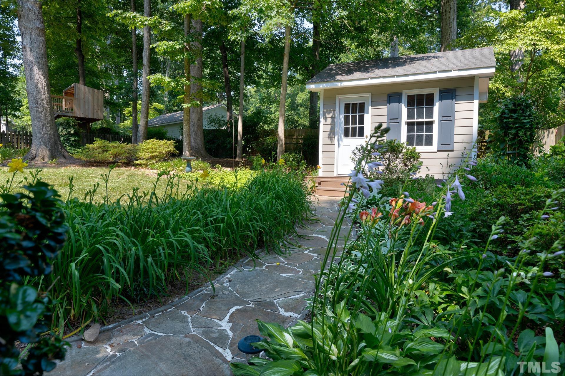613 Ortega Road Raleigh, NC 27609 - Photo 31 of 37 a front view of a house with garden