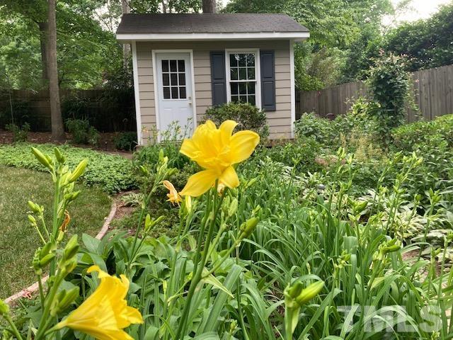 613 Ortega Road Raleigh, NC 27609 - Photo 33 of 37 a view of a house with a backyard and a garden