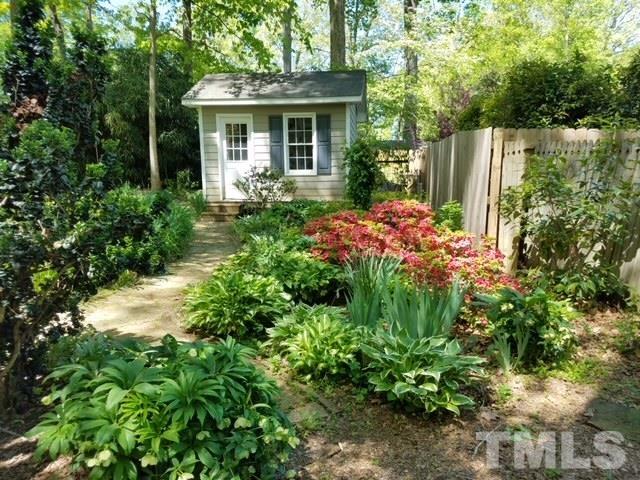 613 Ortega Road Raleigh, NC 27609 - Photo 35 of 37 a front view of a house with a yard and potted plants