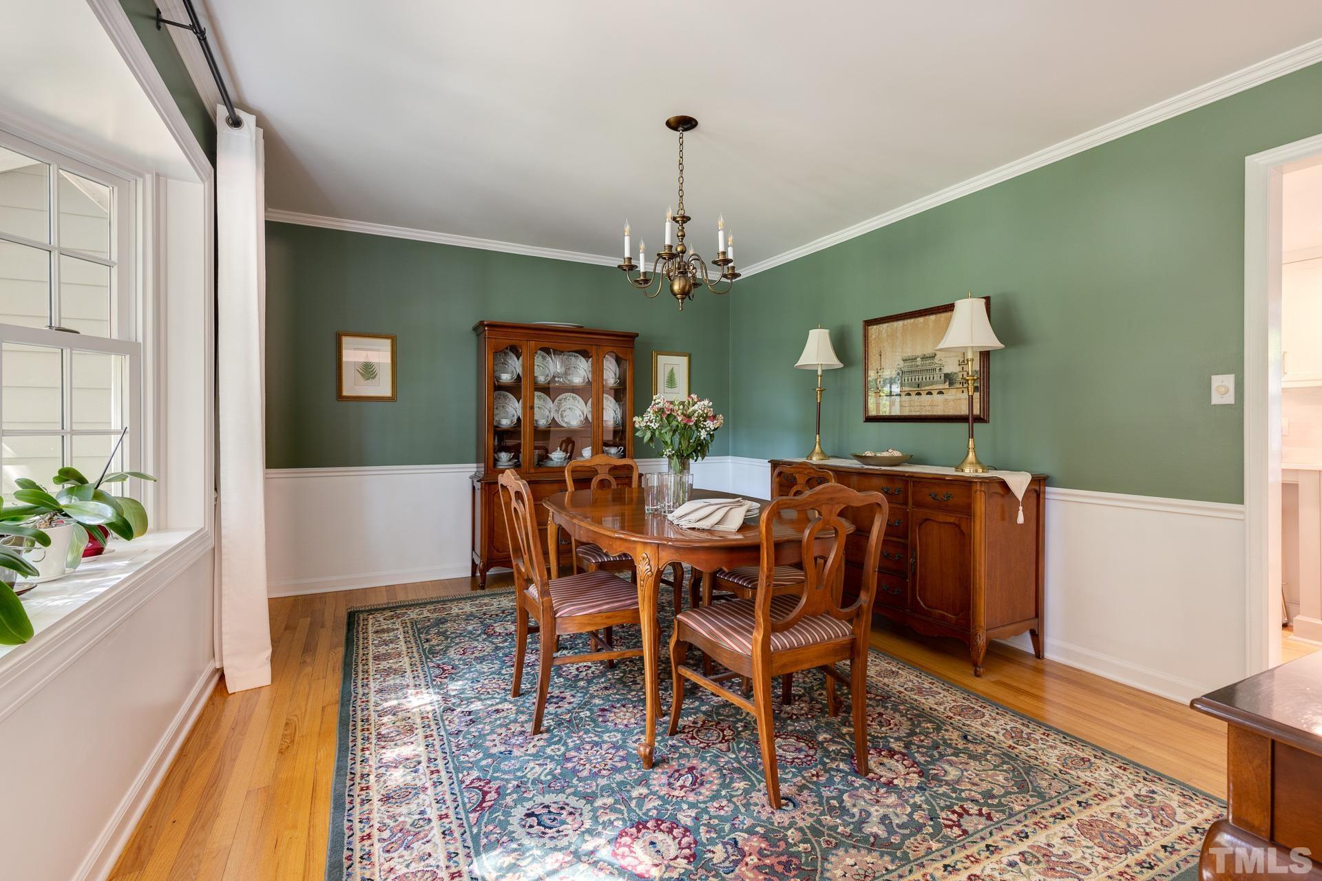 613 Ortega Road Raleigh, NC 27609 - Photo 5 of 37 a view of a dining room with furniture window and wooden floor