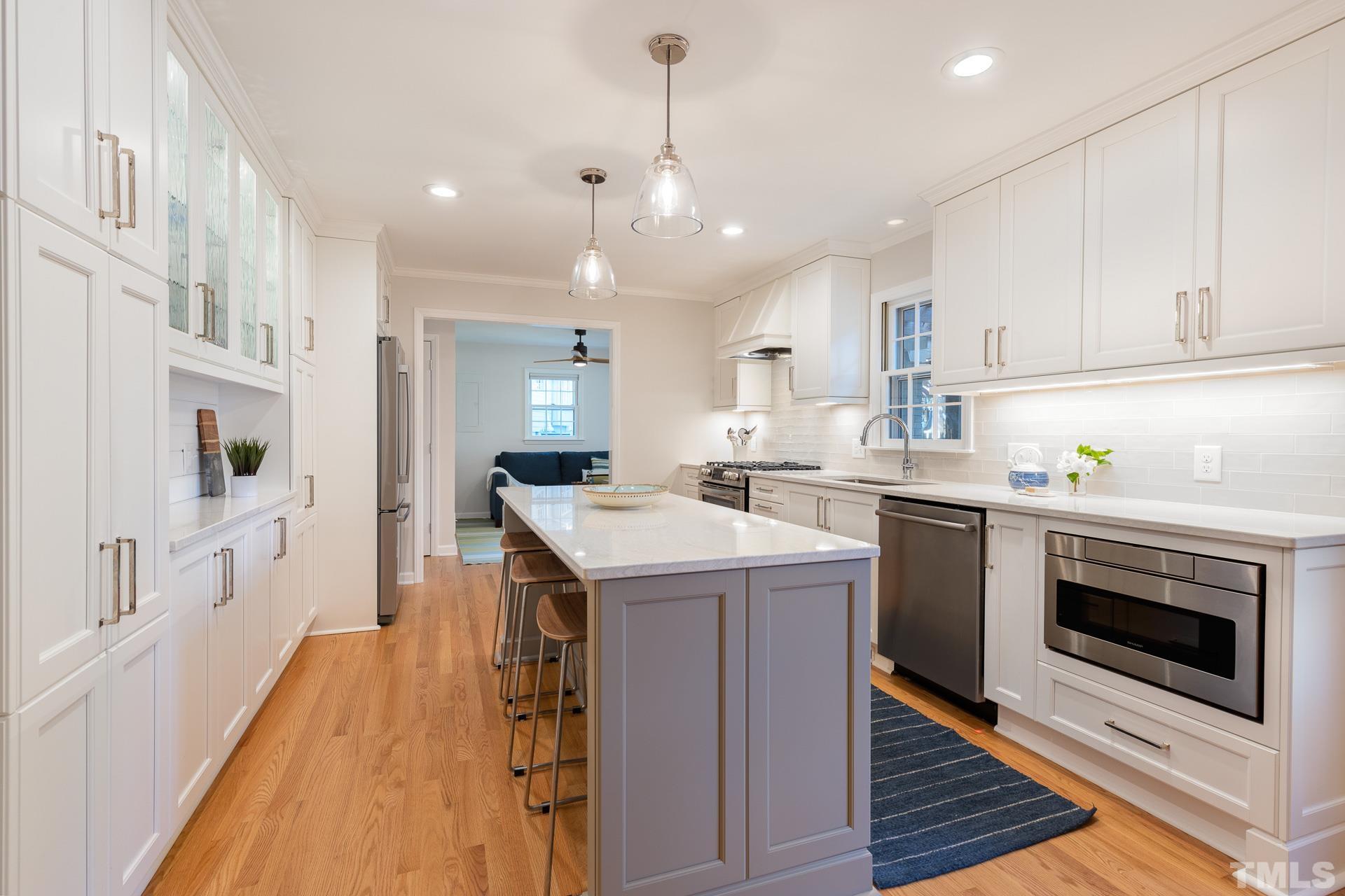 613 Ortega Road Raleigh, NC 27609 - Photo 6 of 37 a kitchen with a sink stove and cabinets