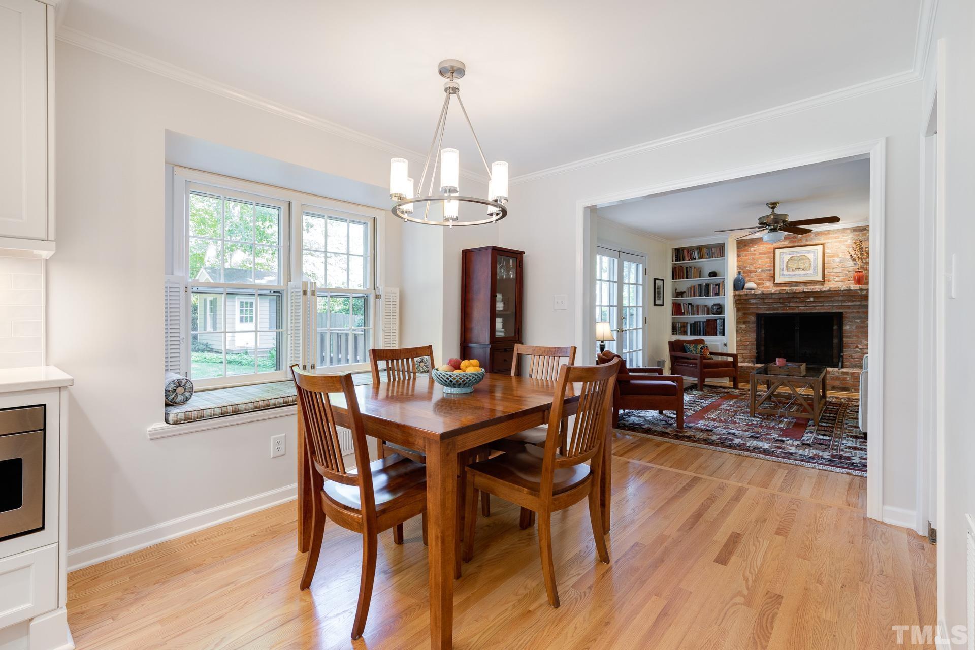 613 Ortega Road Raleigh, NC 27609 - Photo 10 of 37 a view of a dining room with furniture window and wooden floor
