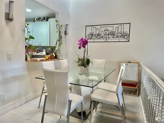 a dining room with furniture large window and refrigerator