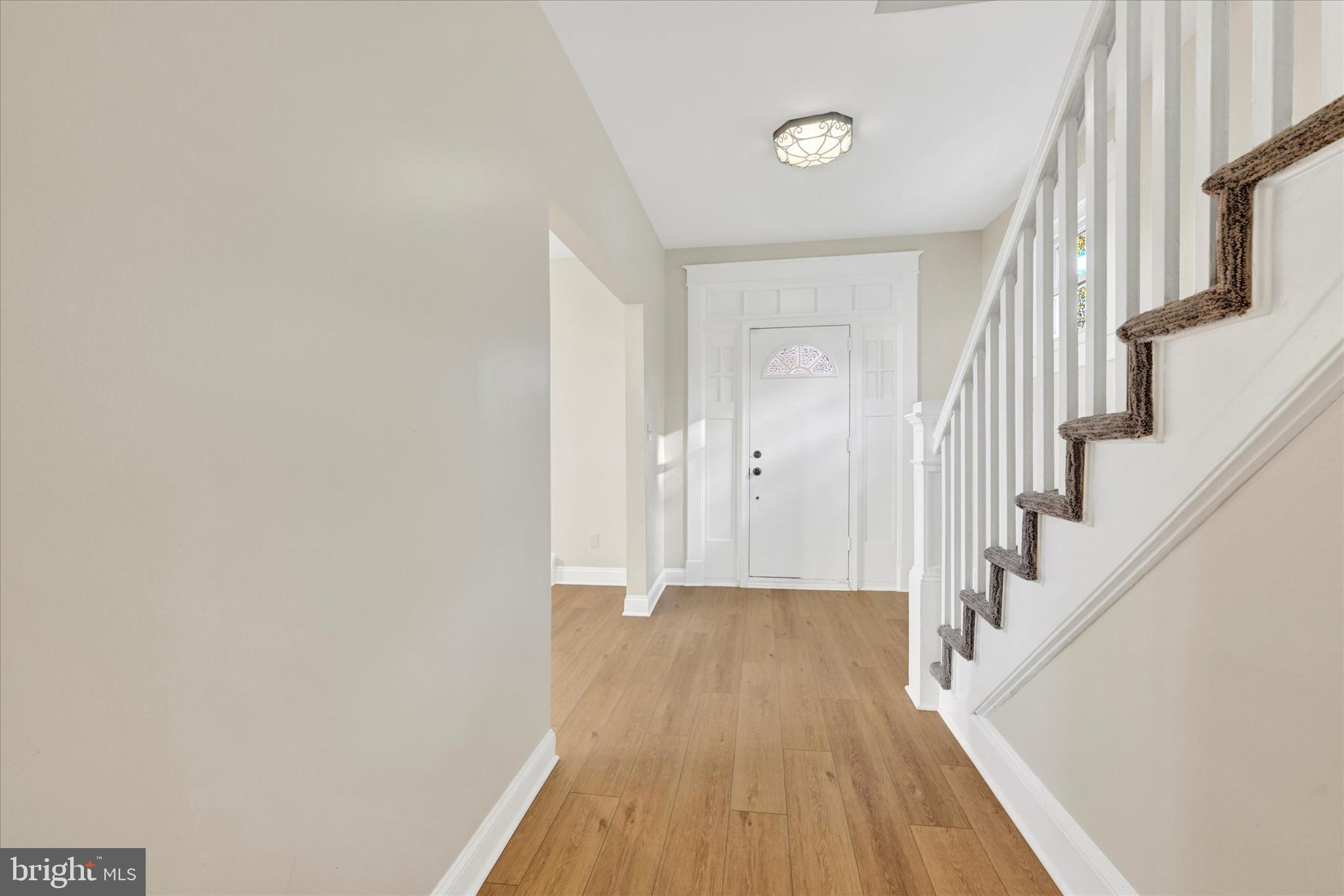 3113 California Avenue Baltimore, MD 21234 - Photo 11 of 29 a view of a hallway with wooden floor and staircase