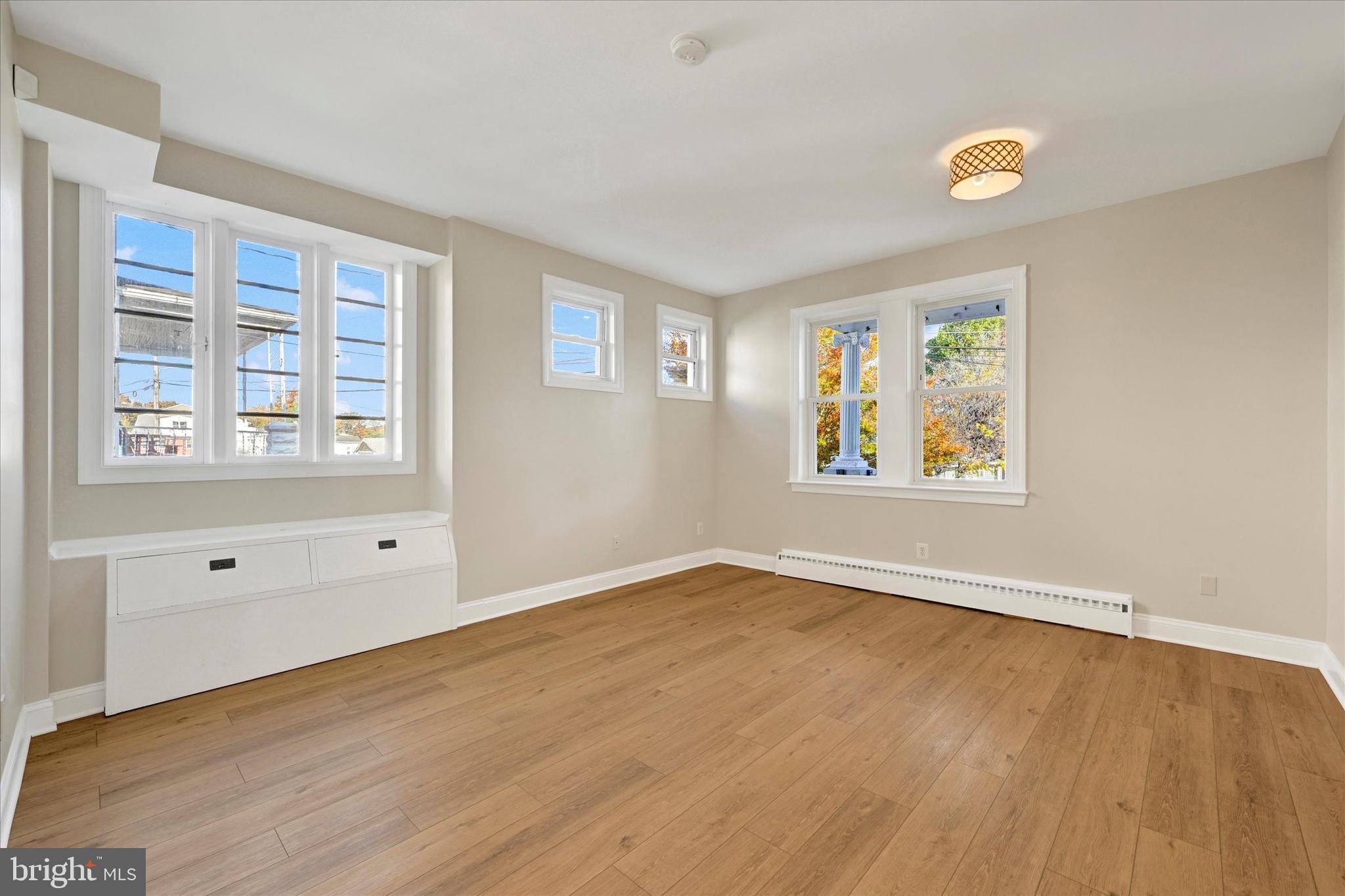 3113 California Avenue Baltimore, MD 21234 - Photo 12 of 29 an empty room with wooden floor and windows