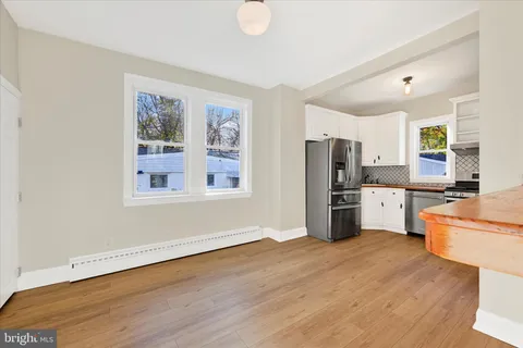 a kitchen with stainless steel appliances a refrigerator and a stove top oven