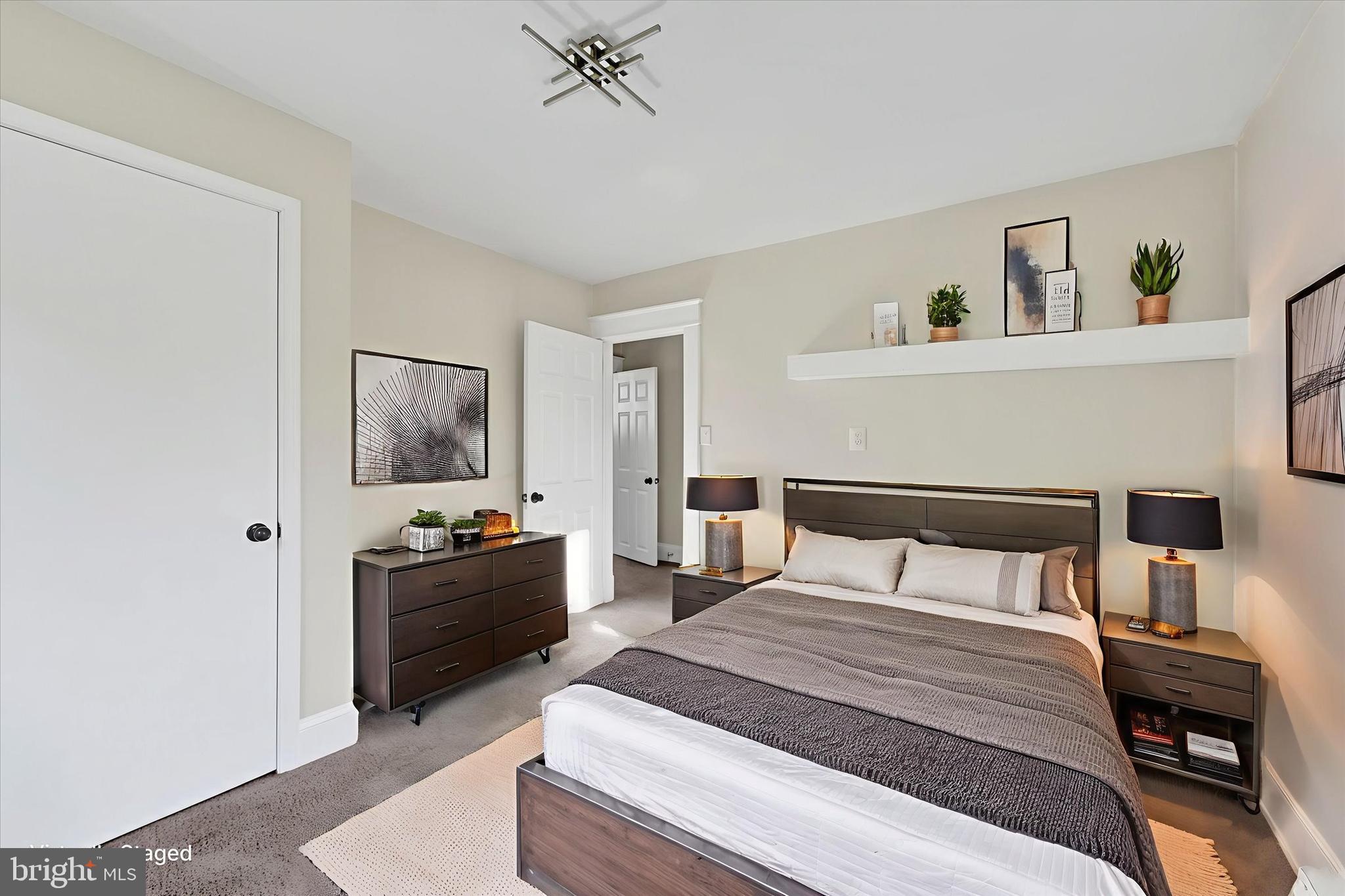 3113 California Avenue Baltimore, MD 21234 - Photo 18 of 29 a bedroom with a bed and a chandelier