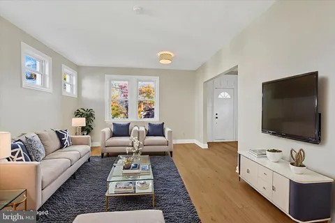 an empty room with windows and ceiling fan