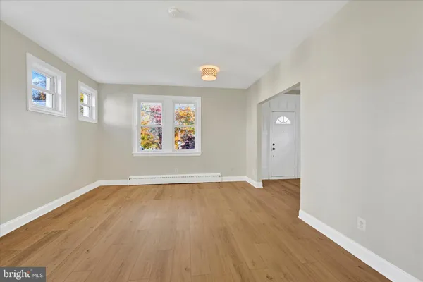 a kitchen with granite countertop stainless steel appliances and wooden floor