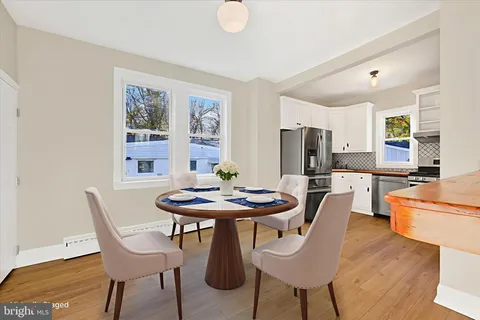 a view of a dining room with furniture and wooden floor