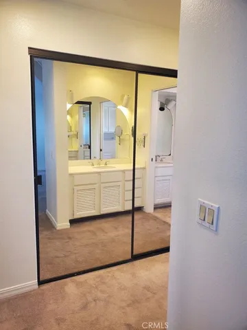 a en suite bathroom with a sink shower and a mirror