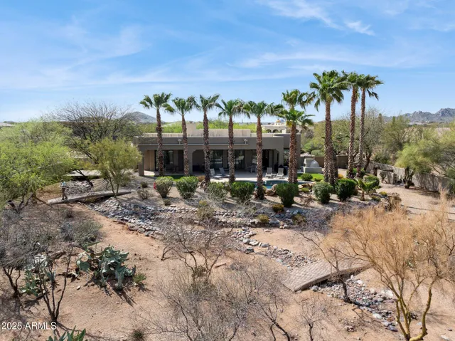 a view of a garden with a building in the background
