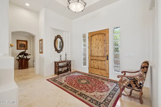a living room with furniture fireplace and a large window