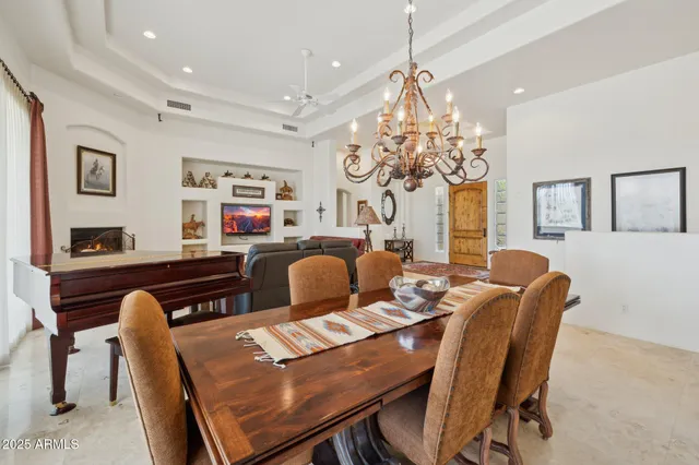 a kitchen with a stove a sink a microwave a dining table and chairs