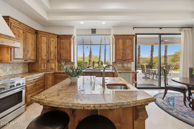 a dining room with furniture and a floor to ceiling window