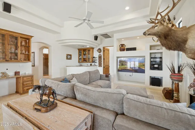 a bedroom with a bed and a couch next to a window